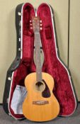 A Yamaha F3-325 acoustic guitar with hard case
