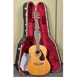 A Yamaha F3-325 acoustic guitar with hard case