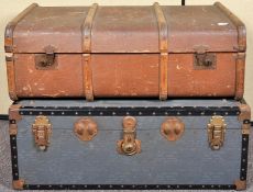 A canvas and wooden bound steamer trunk along with another trunk