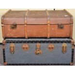 A canvas and wooden bound steamer trunk along with another trunk