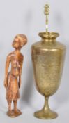 Benares brass and chased decorated vase and a carved figure of an African pregnant lady.