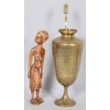 Benares brass and chased decorated vase and a carved figure of an African pregnant lady.