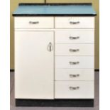 A formica topped kitchen unit having two drawers over cupboard adjacent to a bank of five drawers,