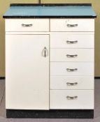 A formica topped kitchen unit having two drawers over cupboard adjacent to a bank of five drawers,