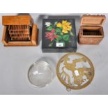 A collection of boxes along with a trivet stand and tray