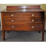 An Edwardian inlaid mahogany chest on legs having a gallery back with two over two configuration,