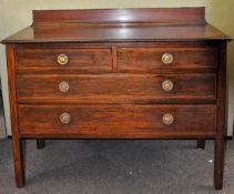 An Edwardian inlaid mahogany chest on legs having a gallery back with two over two configuration,