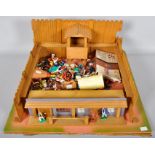 A wooden toy fort with plastic cowboy and Indian figures, Britains,