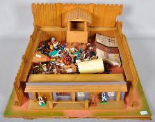 A wooden toy fort with plastic cowboy and Indian figures, Britains,