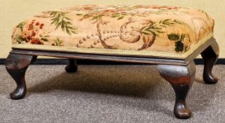 A mahogany footstool with floral style upholstery. Measures; 27cm x 60cm x 44cm.