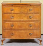 A reproduction chest of two short and three long drawers, fitted brushing slide,