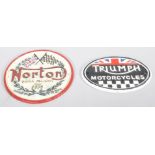 Two replica cast metal signs for Triumph motorcycles and Norton. Largest measures; 22cm.