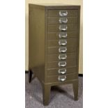 A contemporary thin drawer index filing cabinet raised on legs. Measures; 74cm x 28cm x 41cm.