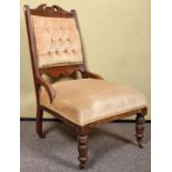 A late 19th Century Victorian nursing chair with button back upholstery,