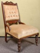 A late 19th Century Victorian nursing chair with button back upholstery,