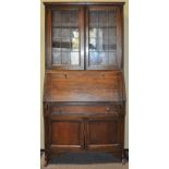 An oak bureua bookcase with glazed doors