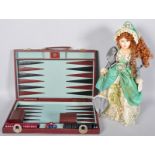 A porcelain doll and a backgammon set