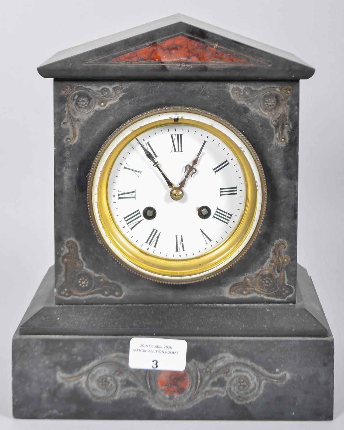 A pointed pediment slate clock with incised scrolled decoration having a white enamel face