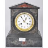 A pointed pediment slate clock with incised scrolled decoration having a white enamel face