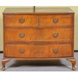 A reproduction low chest of two short and two long drawers on cabriole supports,