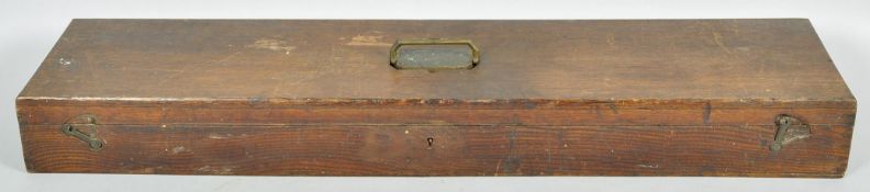 A vintage stained oak rectangular gun case with brass campaign style handle atop,