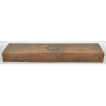 A vintage stained oak rectangular gun case with brass campaign style handle atop,