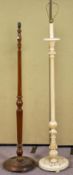 A white painted standard lamp along with an oak example. Measures; 155cm high.