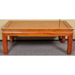 A Chinese style lacquered coffee table. Measures; 37cm x 91cm x 46cm.