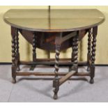 An oak barley barley twist drop leaf and gate leg dining table. Measures; 73cm x 108cm x 55cm.