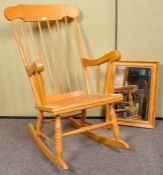 A contemporary pine rocker/rocking chair with tall spindle backrest, saddle seat,