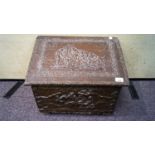 A 20th Century log box with brass relief decorated scenes with hinged lid atop