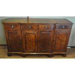 A reproduction Mahogany breakfront sideboard having two central drawers above a twin door cupboard