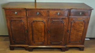 A reproduction Mahogany breakfront sideboard having two central drawers above a twin door cupboard