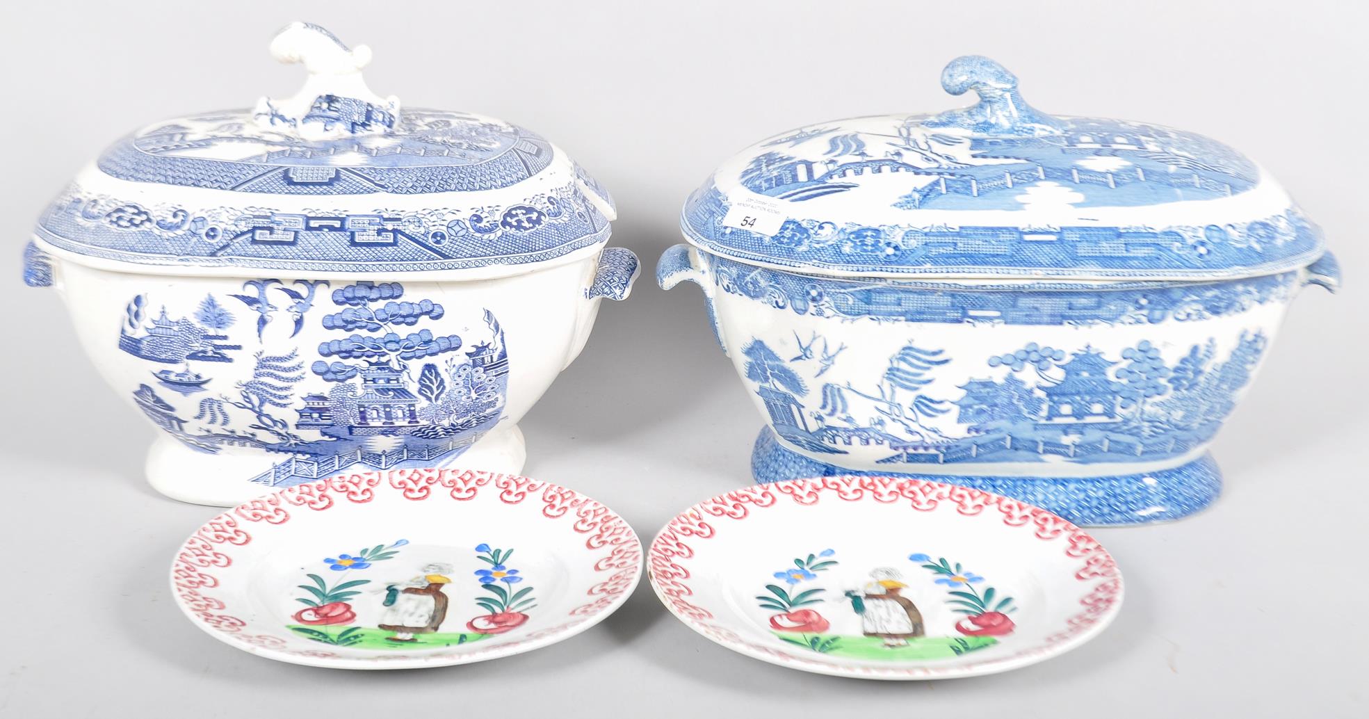 Two Quimper style plates along with two large blue and white willow pattern tureens both A/F.