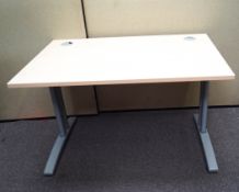 A contemporary office desk raised on legs and splayed. Measures; 72cm x 120cm x 80cm.