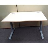 A contemporary office desk raised on legs and splayed. Measures; 72cm x 120cm x 80cm.