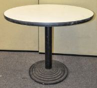 A 20th Century retro round table on iron stepped base.