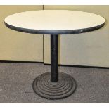 A 20th Century retro round table on iron stepped base.