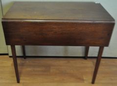 An early 20th Century mahogany Pembroke table raised on squared straight legs.