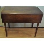 An early 20th Century mahogany Pembroke table raised on squared straight legs.