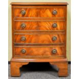 A small regency revival chest of drawers having four drawers each with loop handles,