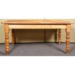 A contemporary pine rectangular kitchen table, raised on turned legs. Measures; 77cm x 168cm x 81cm.