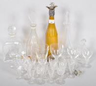 A collection of glassware to include four decanter of varying shapes and sizes.