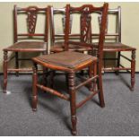 A set of four Edwardian mahogany chairs with pierced splat back, upholstered and padded seat,