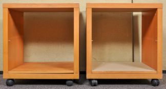 A pair of Ikea shelved storage units on castors. Measures; 58cm x 52cm x 40cm.