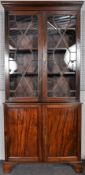 An Edwardian mahogany astragal glazed bookcase over drawers. Measures; 207cm x 97cm x 35cm.