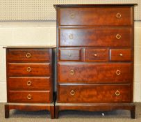 A Stag Minstrel chest of drawers having a run of seven and two bedside tables.