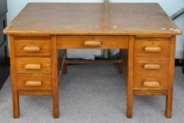 An oak twin pedestal desk 1950s, 137cm wide, 76cm deep,