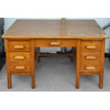 An oak twin pedestal desk 1950s, 137cm wide, 76cm deep,