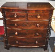 A mahogany two over three chest of drawers raised bracket leg.